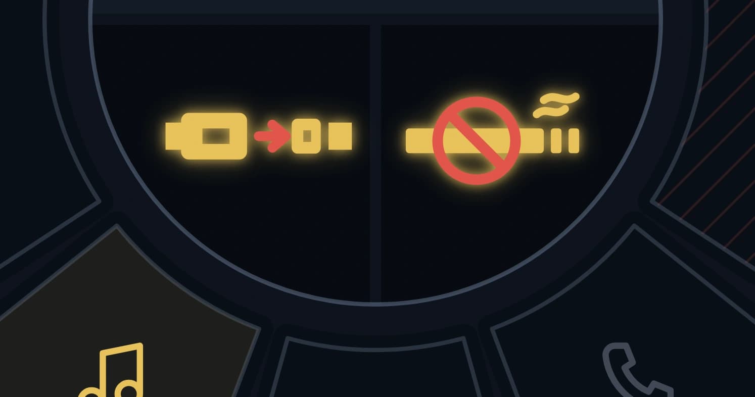 The lower half of the console's hub, split into two quarters — the seat-belt placard glowing gold with a red buckle arrow, and the no-smoking placard glowing gold with a red prohibition ring